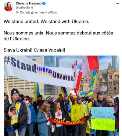 Chrystia Freeland demonstrating with the OUN(B) Banderites against Russian aggression in Ukraine. The small banner is in the black and red colors of the Banderites. It bears the slogan of the Banderites 